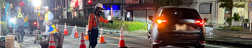 守口市での道路舗装本復旧工事現場で交通誘導警備中の警備員（2023.06.27）