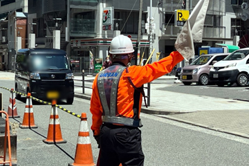 浪速区の道路舗装工事現場で交通誘導警備中の警備員2(2024.05.14)